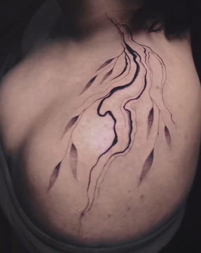 fluid flow abstract lines leaves tattoo female shoulder