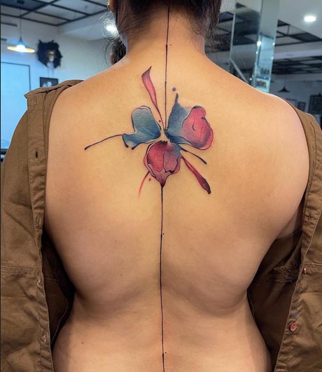 watercolor abstract colored flower tattoo design female back