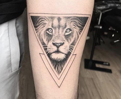 fierce lion in a triangle tattoo