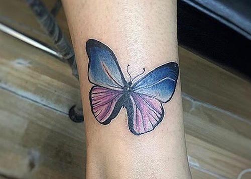 colorful butterfly tattoo on ankle