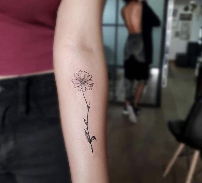 Simple flower tattoo on the back of the arm - Tattoogrid.net