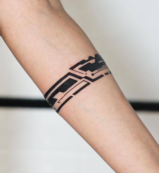 bold black abstract geometric pattern armband tattoo blackwork female forearm