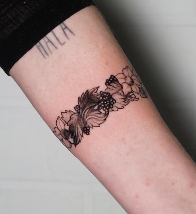 floral armband tattoo design idea feminine forearm