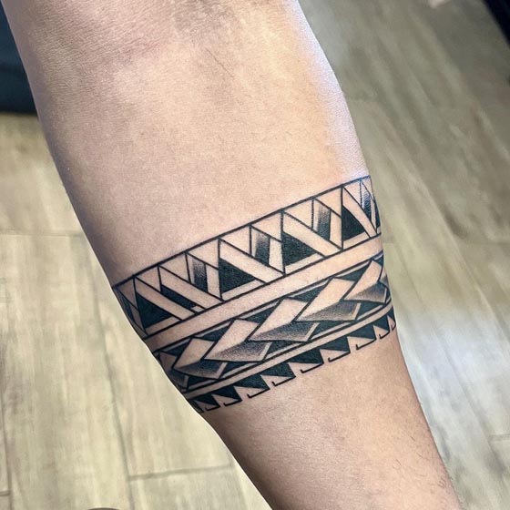geometric polynesian tribal motifs armband tattoo male forearm