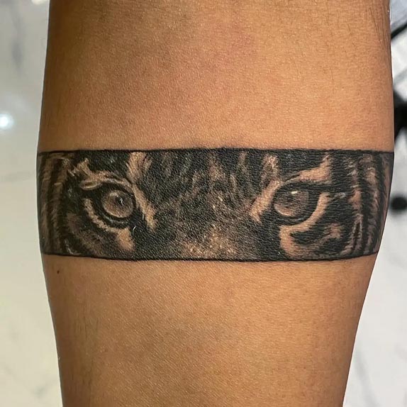 tiger eyes stripes armband tattoo design male forearm