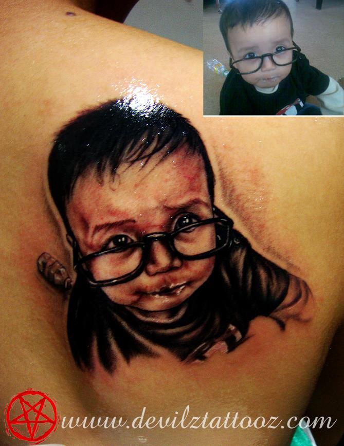 baby portrait black and grey back tattoo