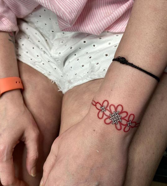 wrist band infinity knot tattoo design female hand
