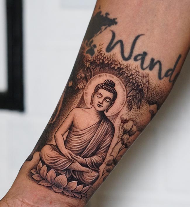 buddha sitting on lotus and background bodhi tree flowers tattoo male arm