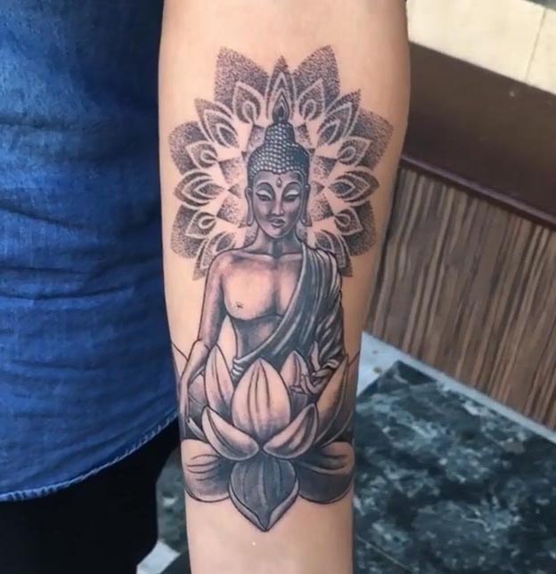 buddha sitting on lotus mandala back of head tattoo design male forearm black and grey