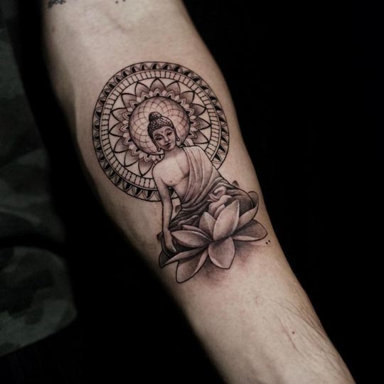 buddha sitting on lotus with mandala background tattoo male forearm