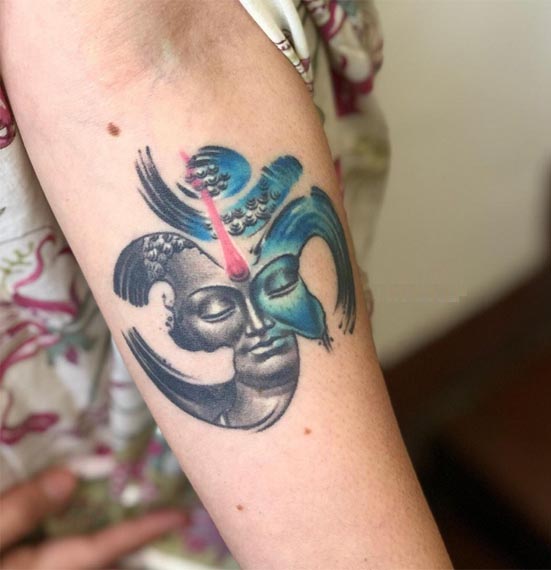 realistic buddha merged with om symbol tattoo design female forearm