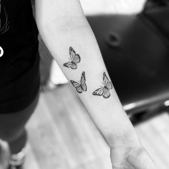 3 butterfly tattoo design female hand forearm black and grey