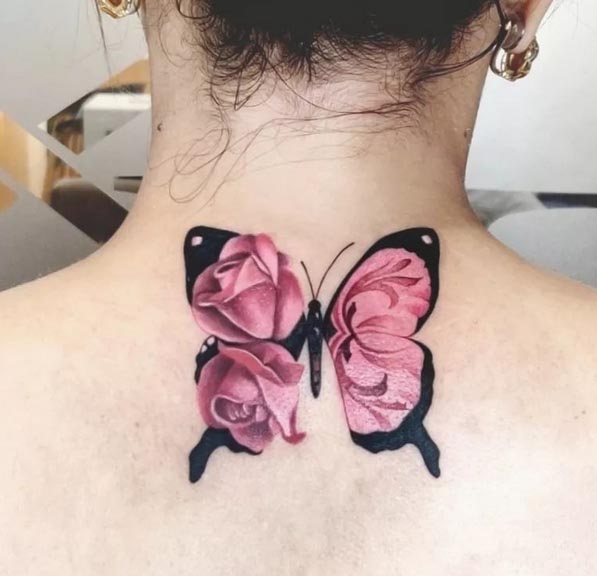 pink flowers on butterfly wings tattoo design female back