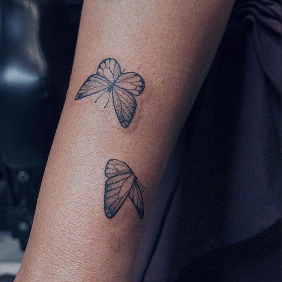 tiny 2 butterfly tattoo design linework female forearm