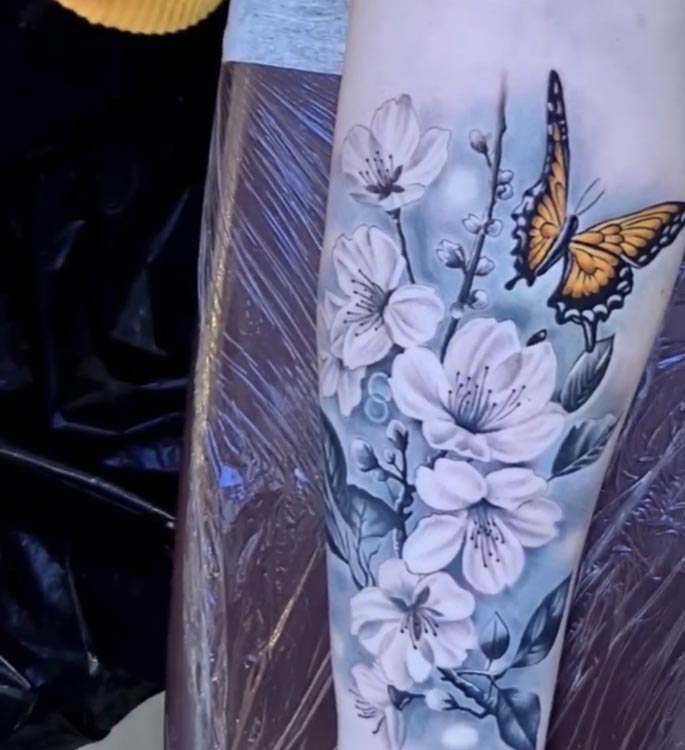 yellow butterfly with flowers and light blue background