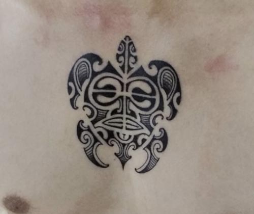 aztec face turtle tattoo on chest