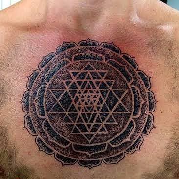 dot art mandala tattoo on chest