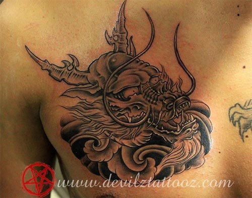 dragon face tattoo on chest