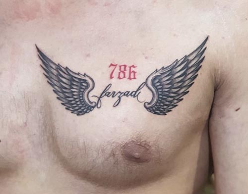 name with wings tattoo on chest