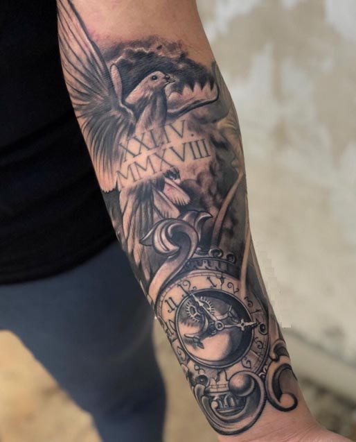 flying bird dove pocket watch clock exposed gears feathers ornamental scrollwork tattoo male forearm