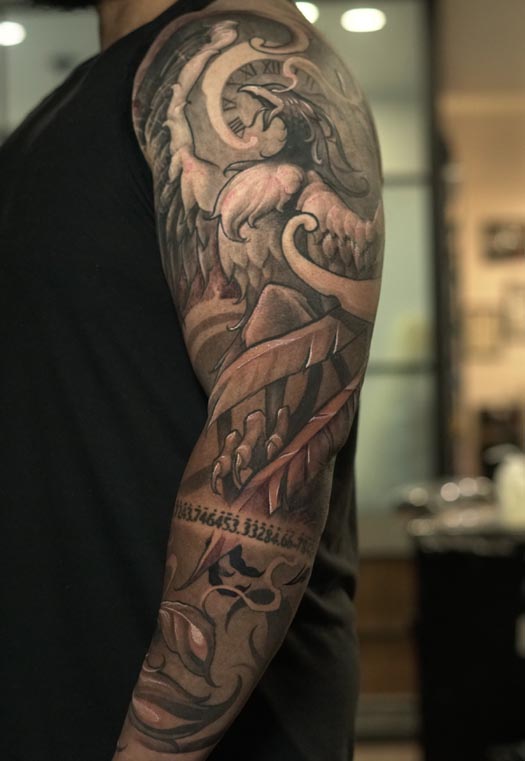 phoenix clock roman numerals wings feathers mountains smoke musical notes full sleeve tattoo male