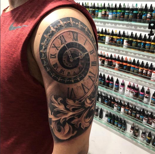 spiral clock ornamental frame decorative scrollwork swirling patterns tattoo male bicep shoulder