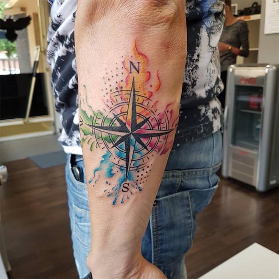 compass-cardinal-directional-needle-watercolor-splashes-paint-strokes-tattoo-male-outer-forearm