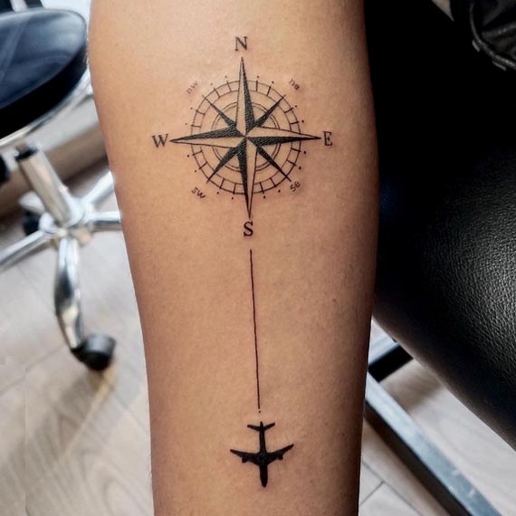 compass-cardinal-directions-directional-needle-airplane-silhouette-tattoo-male-inner-forearm