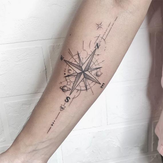 compass cardinal directions n s e w letters geometric circles planets stars moon phases tattoo male inner forearm