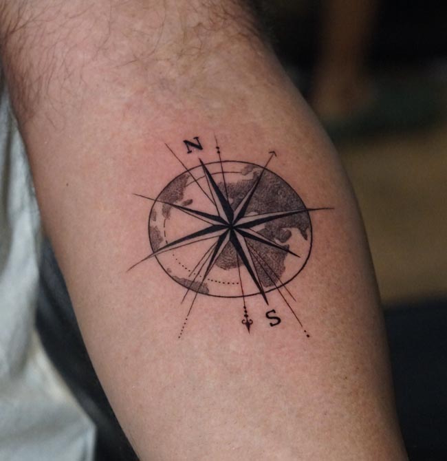 compass cardinal directions n s markings circular world map tattoo male arm
