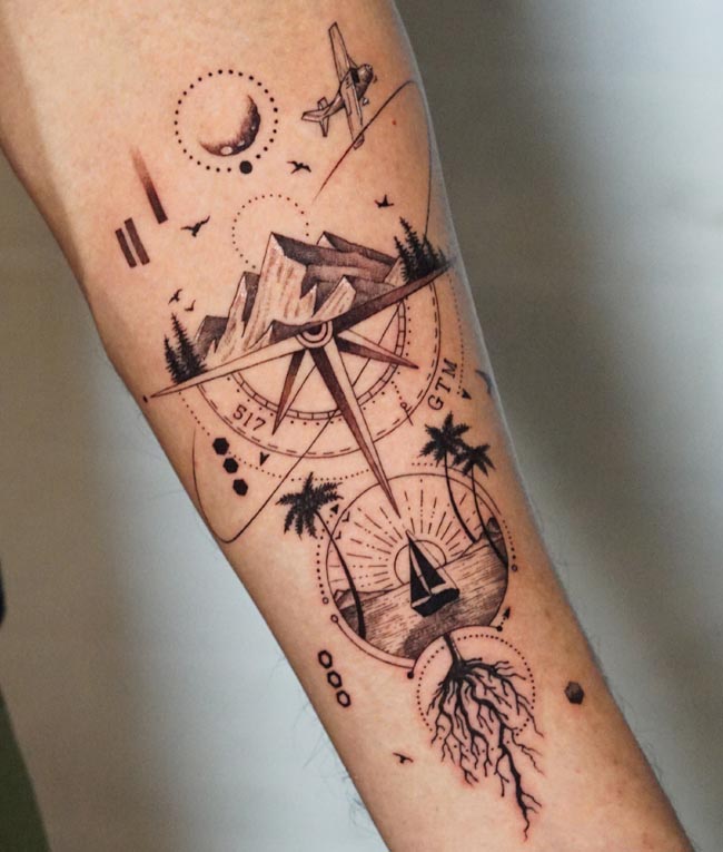 compass mountain airplane crescent moon birds palm trees ocean sailboat sun horizon tattoo male forearm