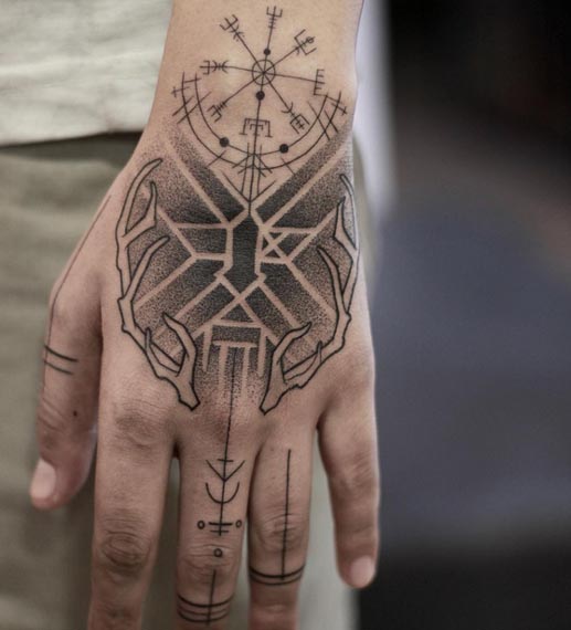 nordic compass vegvisir inspired symbol runes deer antlers geometric pattern arrows dots linework tattoo male hand