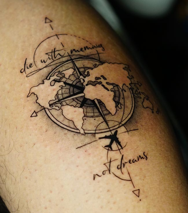 world-map-compass-airplane-flight-path-navigation-arrows-handwritten-quote-tattoo-male-calf