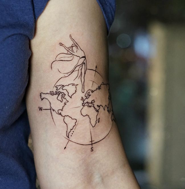 world map compass cardinal directions north south west east dancing woman geographic outlines tattoo female bicep