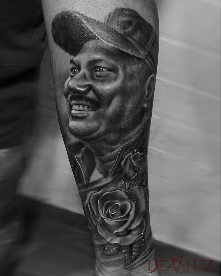back of arm portrait with rose tattoo