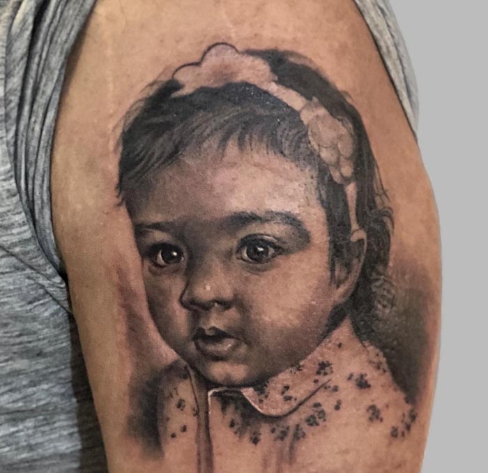 male bicep daughter portrait tattoo