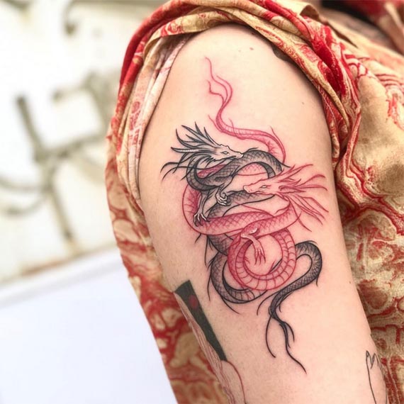 2 dragons tattoo black and red female hand bicep