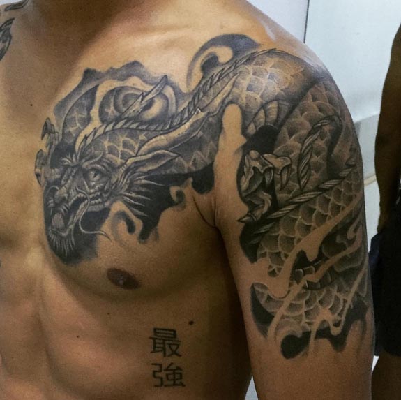 chest shoulder dragon tattoo design male black and grey