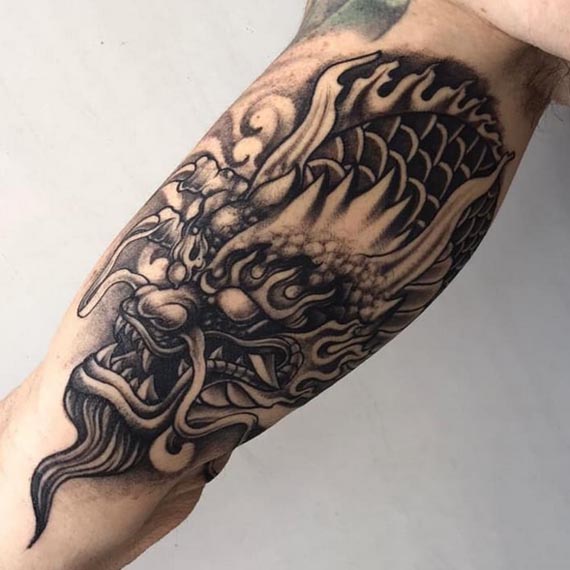 dragon head tattoo design male hand bicep black and grey