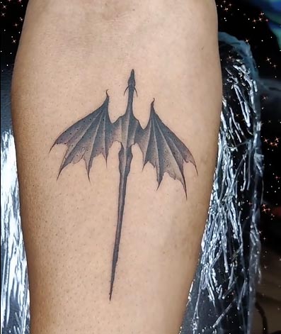 small dragon black and grey tattoo male forearm