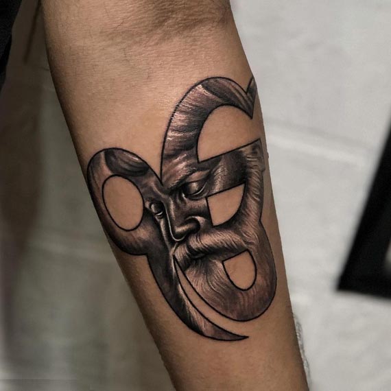 guru nanak dev portrait in ek onkar symbol tattoo design male forearm