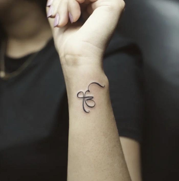 small ek onkar tattoo female wrist