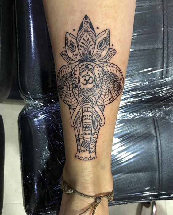 full elephant om on forehead flower on top tattoo mehndi style woman calf