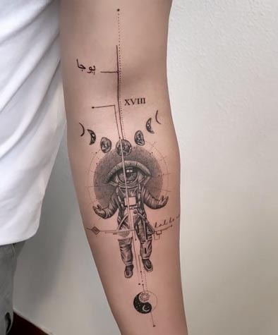 eye as astronaut head moon phases yin yang tattoo fineline male arm