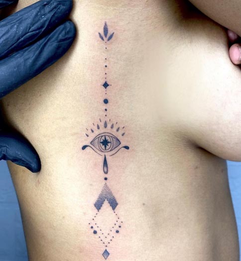 eye ornamental tattoo female side rib