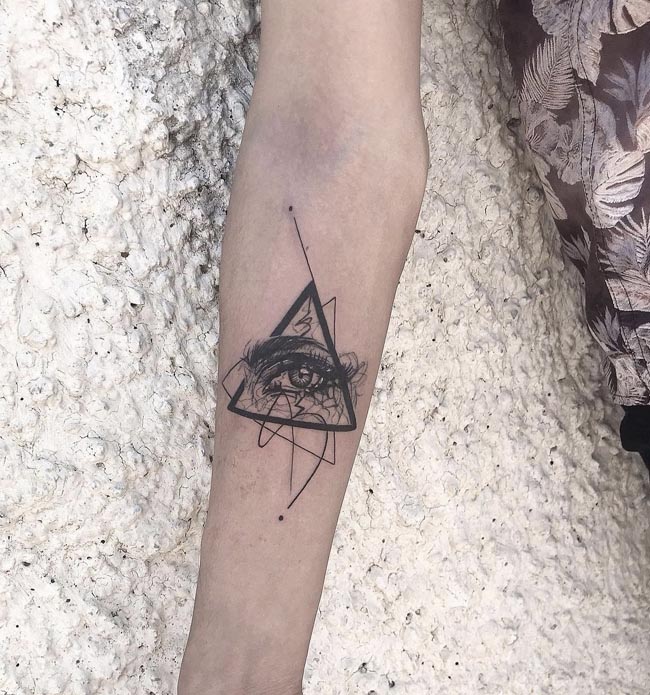 eye placed on double triangles with random lines tattoo male forearm