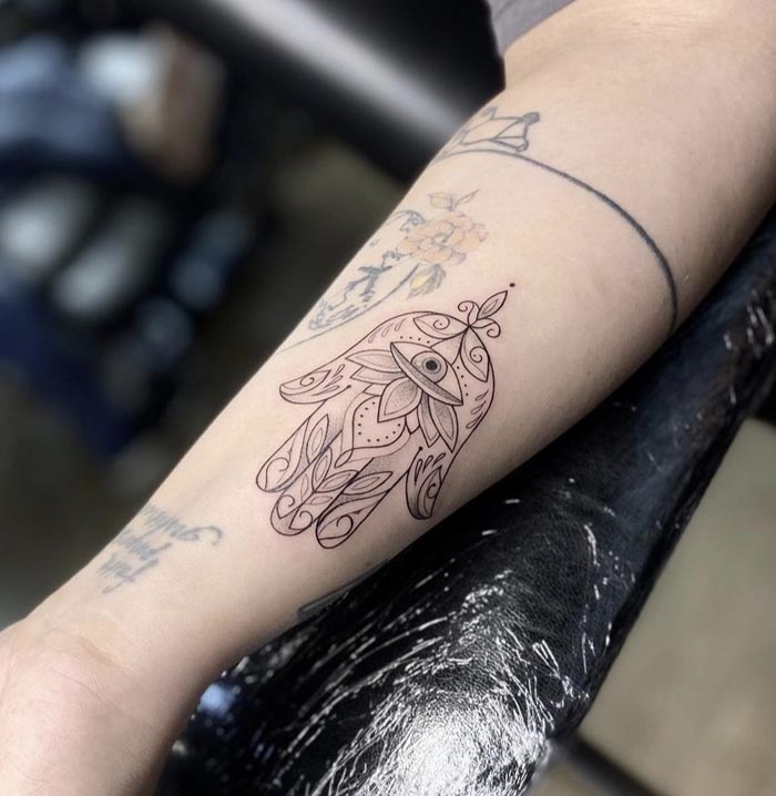 hamsa evil eye tattoo linework female forearm