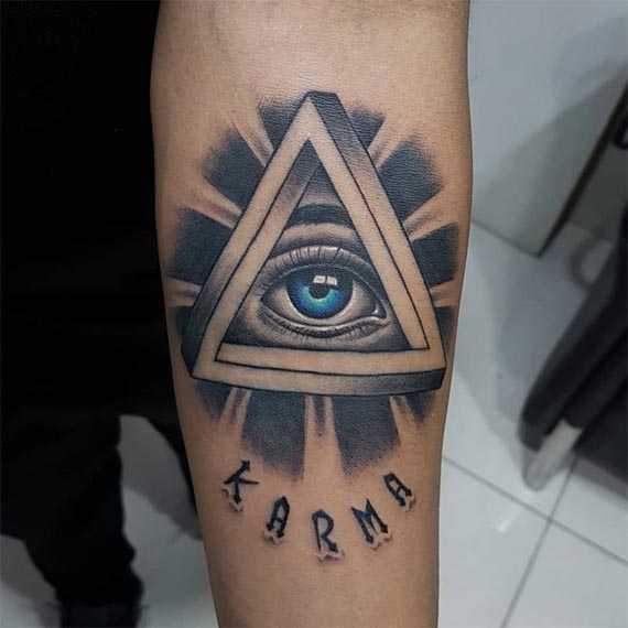 word karma above illuminati eye thick sun rays tattoo design male forearm