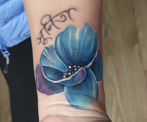 blue flower with name tattoo design