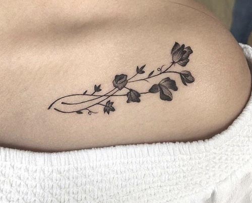 collar bone flower pattern tattoo